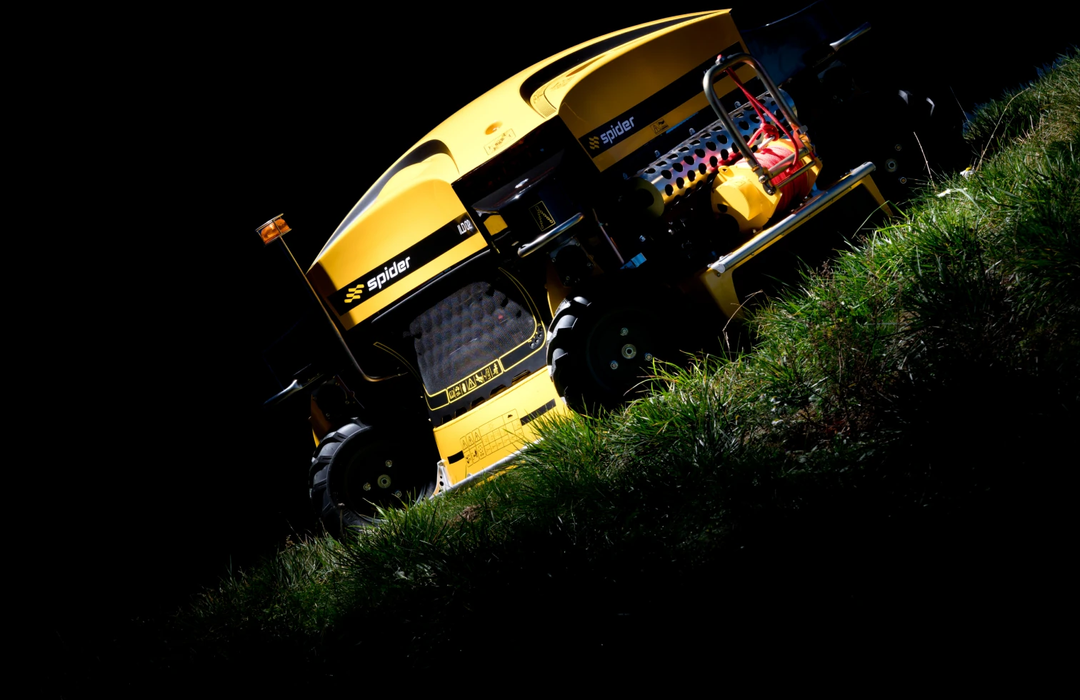 Spider remote-controlled slope mower on a hillside